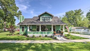 A green two-story house with a front porch, a chimney, and a small garden. - Renovated Craftsman House w/ Patio & Fire Pit! (Vevay)