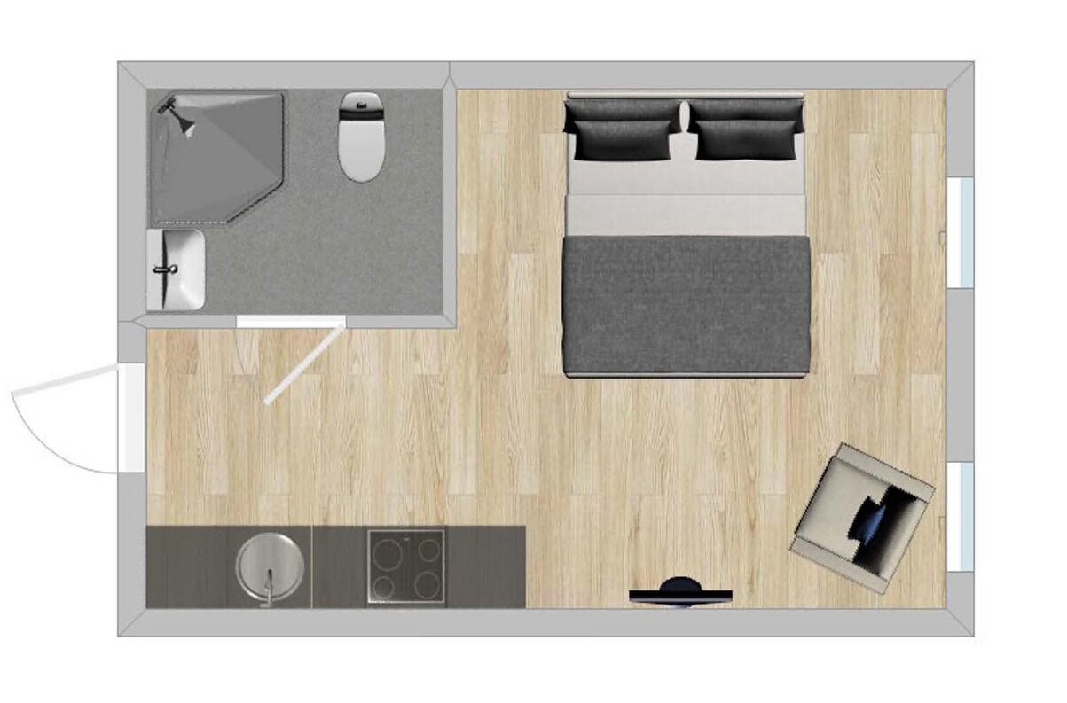 A bedroom with a bed, bedside tables, and a window.