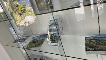 A glass display case with brochures and maps, likely in a travel or tourism setting.
