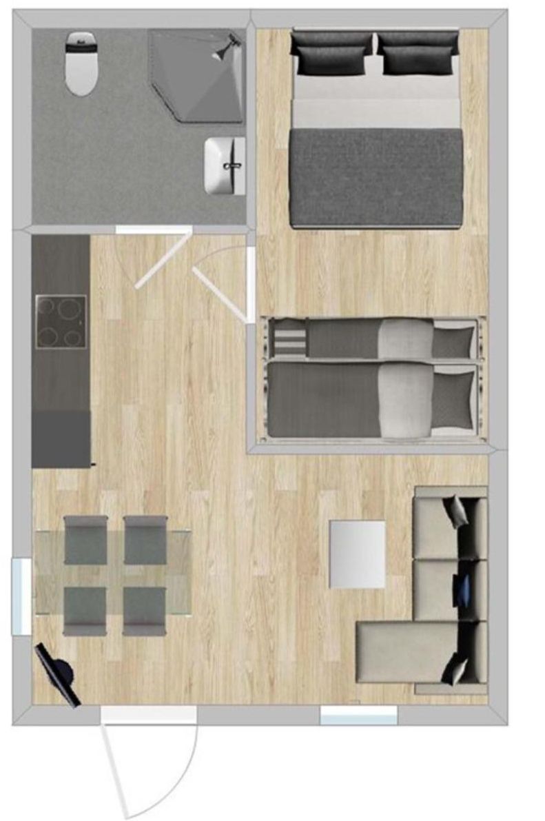 Disposição de quarto de hotel com cama, mesas de cabeceira, escrivaninha, cadeira e uma pequena cozinha.