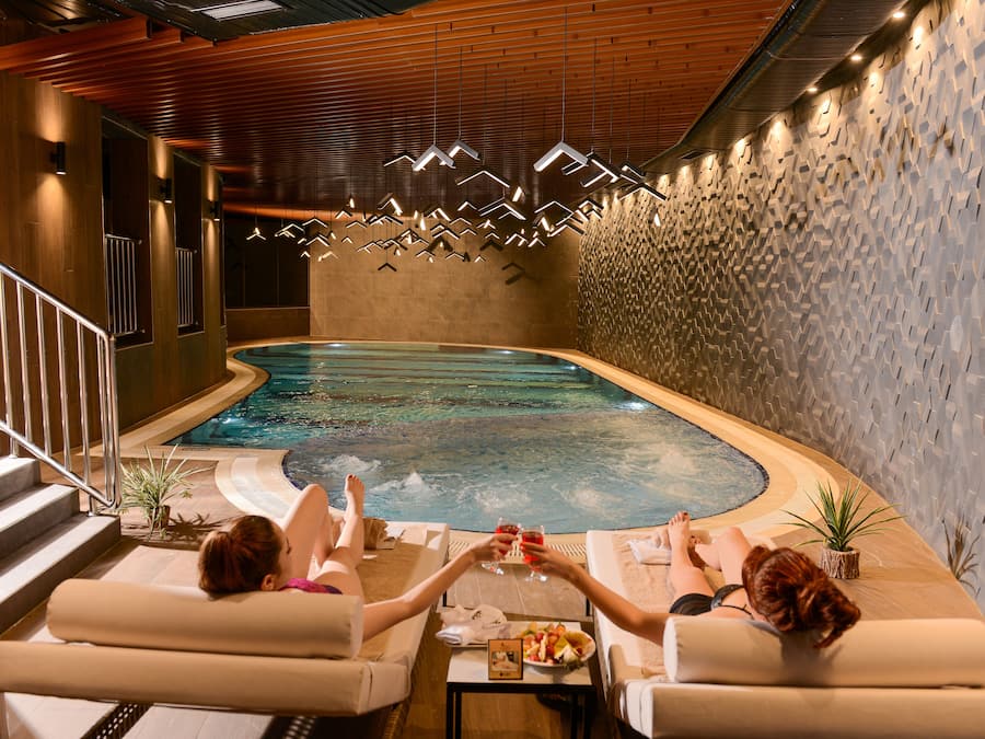 Indoor pool, open 8:00 AM to 10:00 PM, pool loungers