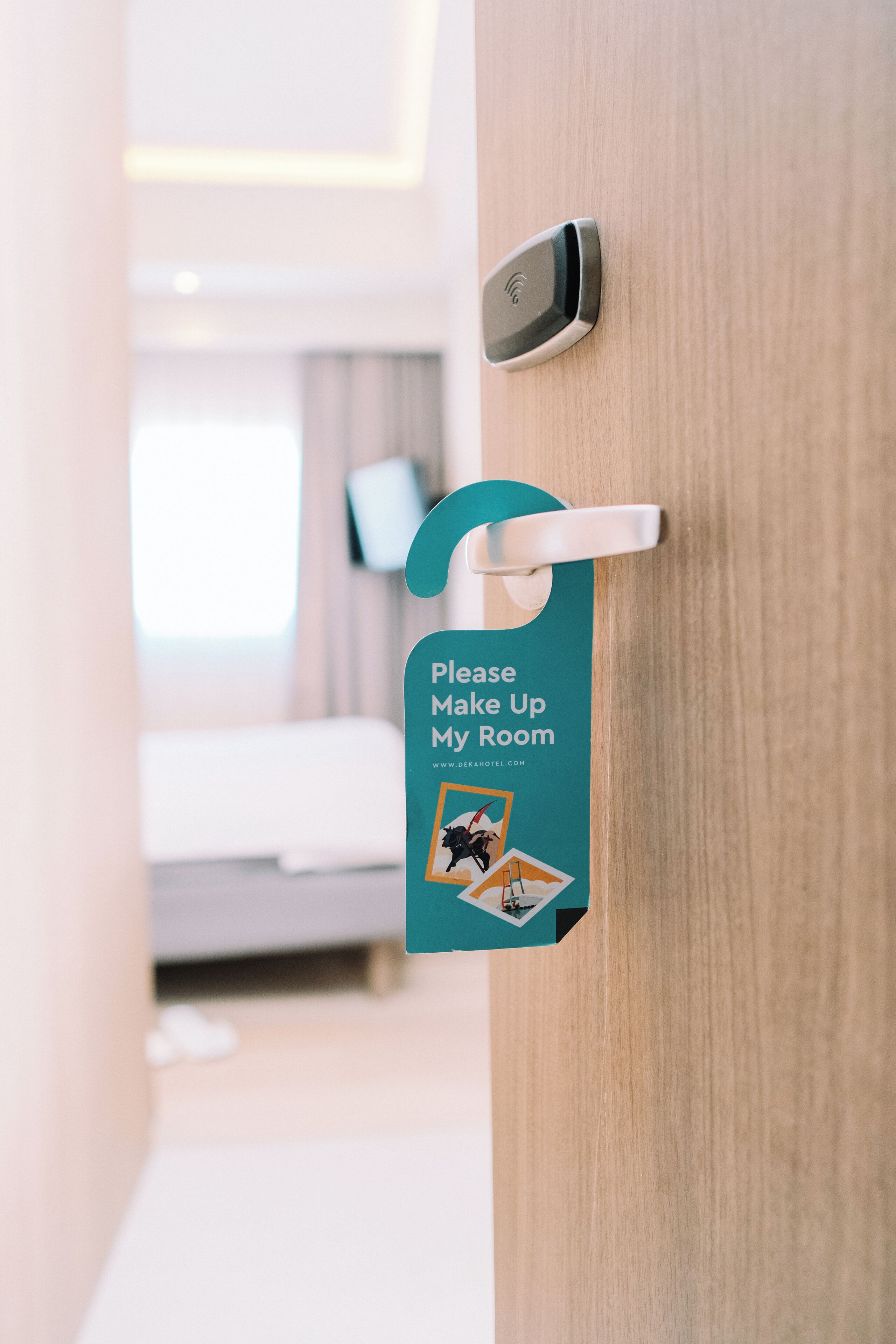 A hotel room door with a sign requesting guests to make up their own room.