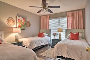 A bedroom with two beds, a ceiling fan, and a window with blinds. - Large Lavonia Home w/ Party Dock on Lake Hartwell! (Lavonia)