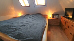 A bedroom with a bed, bedside tables, a TV, and a dresser. - Apartment Seeadlerhorst Oberhof Boltenhagen (Oberhof)
