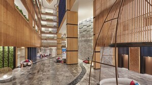 A modern interior with a central atrium, wooden paneling, and seating areas. - Taj Cidade de Goa Horizon, Goa (Panaji)