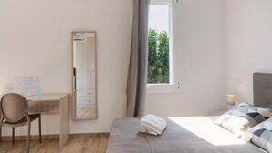 A bedroom with a bed, a desk, a chair, a window with curtains, and a view of greenery outside. - Spacious room with private bathroom is part of the San Vincenzo Rooms Guest House and is perfect for 2 guests. The accommodation is located in the renovated building in Vigonza, which is 10 minutes by car from the center of Padua and on the direct route  (Vigonza)