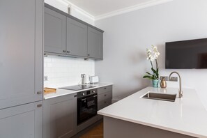 City villa | Privékeuken | Een koelkast met diepvriezer, een microgolfoven, een oven, een kookplaat