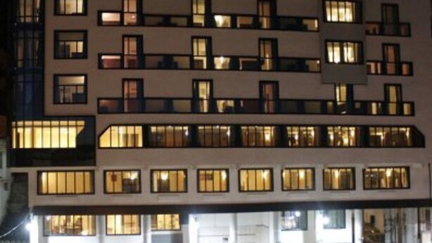 Un hotel de varios pisos con ventanas iluminadas y un letrero que dice "HOTEL DU NORD".