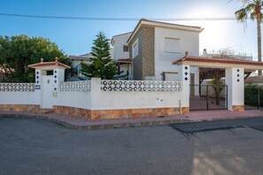 A two-story house with a white exterior, a stone base, and a tiled roof. - Fidalsa Golf & Beach (Ciudad Quesada)