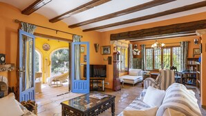 A spacious living room with a fireplace, a television, and a comfortable seating area. - La Golondrina (Javea / Xàbia)