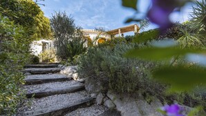 A stone staircase leading up to a building with a wooden pergola. - La Golondrina (Javea / Xàbia)
