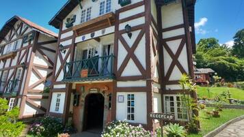 A traditional half-timbered building with a sign reading "RECEPCAO".