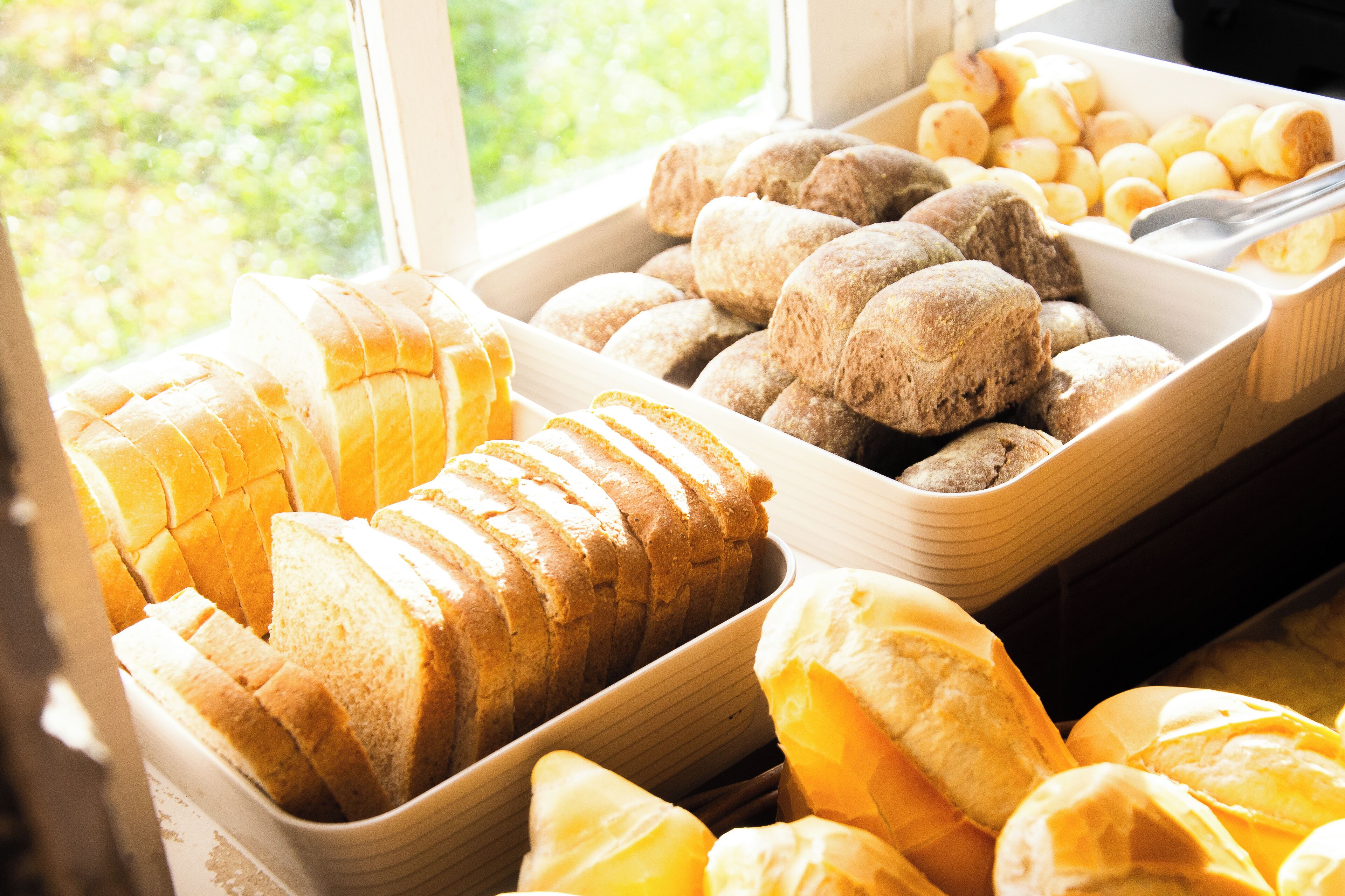 A bakery display with various breads and pastries.