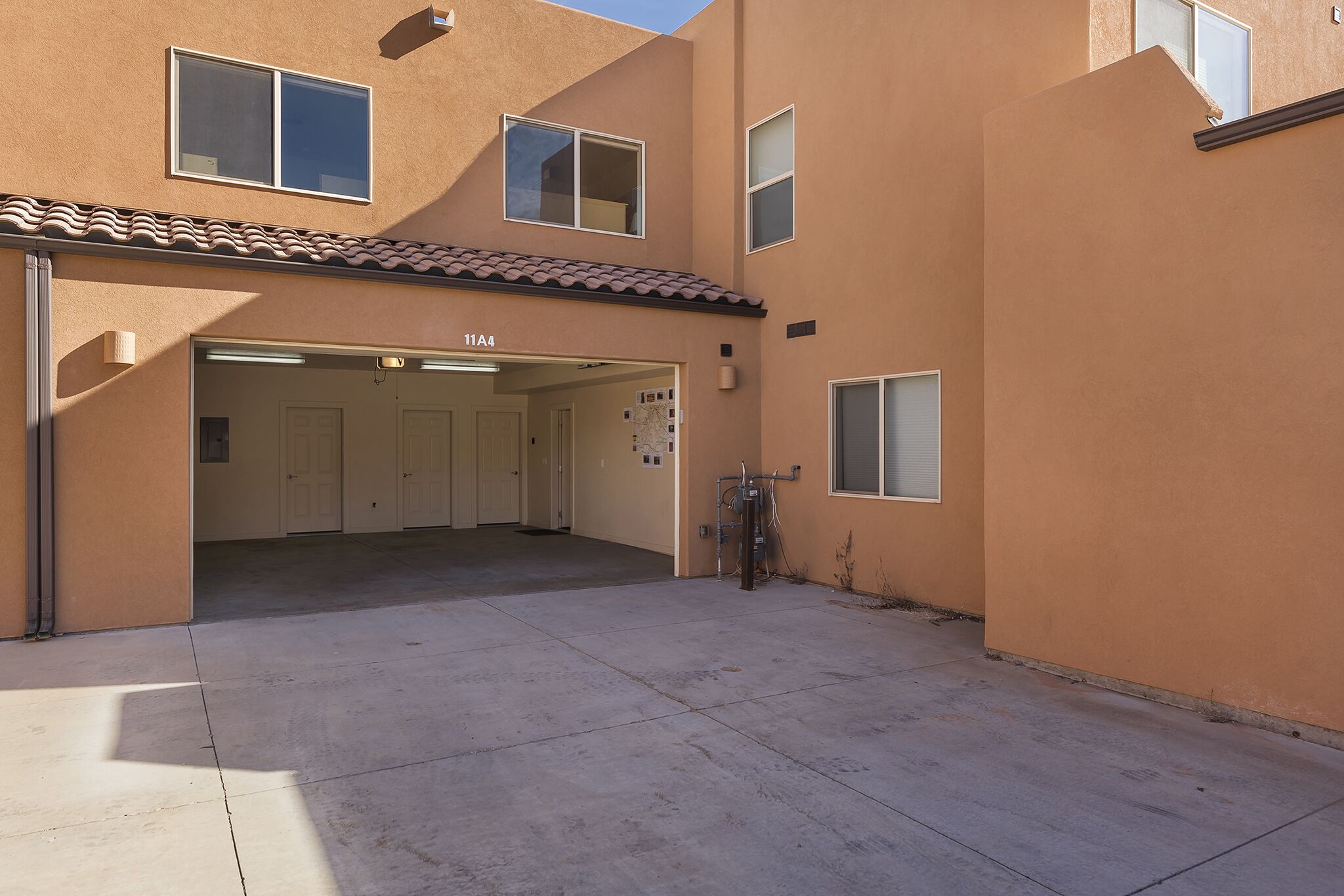 A building with a garage entrance, numbered 111, and a small attached structure with a window.