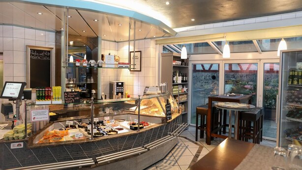 A breakfast buffet area with various food items and a coffee station.