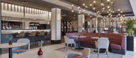 A modern bar area with seating and a bar counter.