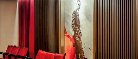 A cinema with red seating and a neon sign reading "RED Radisson".