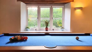 A pool table with balls, a window with plants, and a wall-mounted light fixture. - Beautiful, Quiet, Countryside Cottage in the foothills of the Cotswolds (Witney)