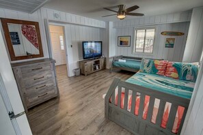 Relax in a comfortable room with a bed, television, and dresser.