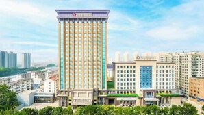 A tall hotel with a modern design, multiple floors, and a prominent entrance. - Rendezvous Hotel (CHANGZHI)