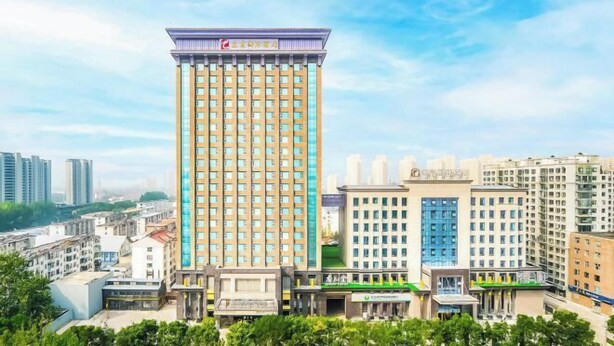 A tall hotel with a modern design, multiple floors, and a prominent entrance. - Rendezvous Hotel (CHANGZHI)