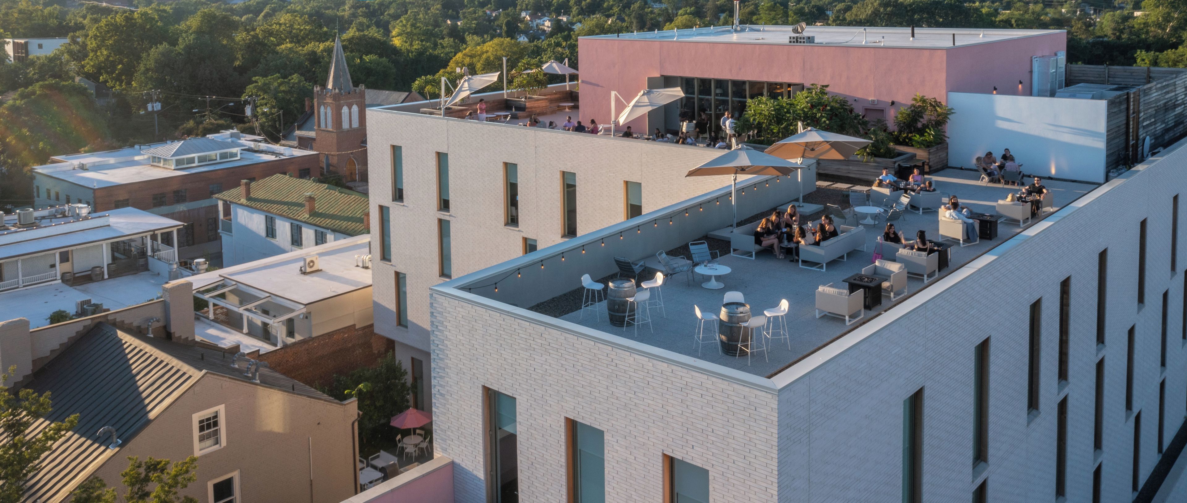 A rooftop terrace with outdoor seating and a view of the cityscape.