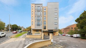 A multi-story residential building with a modern design, featuring a mix of balconies and windows. - Golden Heights 7 (Maidstone)