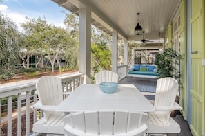 Relax in this serene outdoor seating area with a table and chairs, perfect for enjoying a quiet moment.