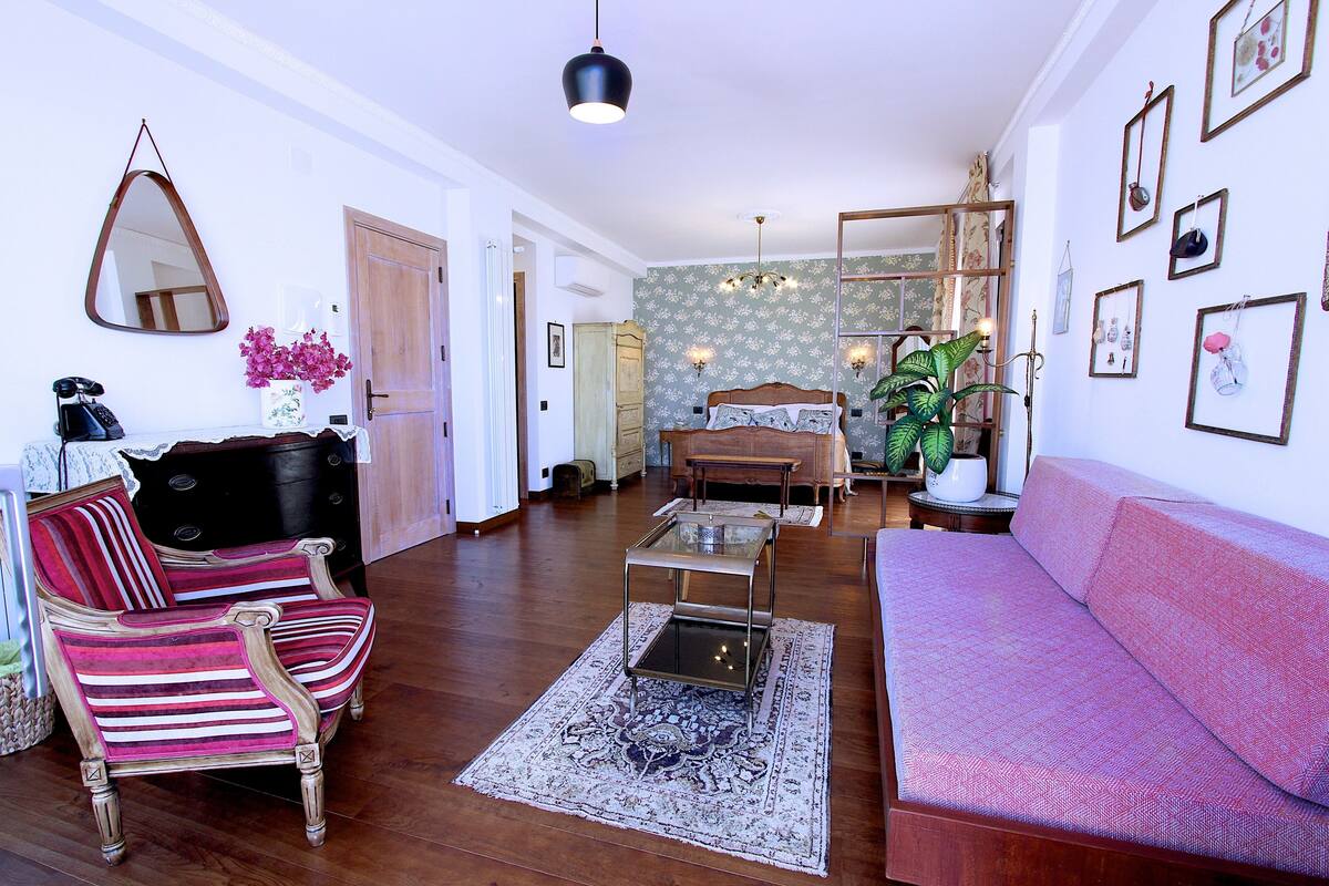 A living room with a sofa, armchair, and a coffee table.