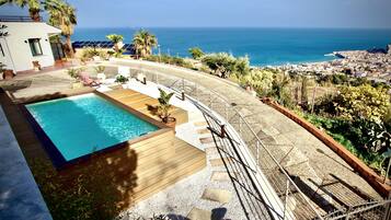 Seasonal outdoor pool, pool loungers