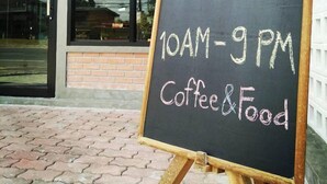 A signboard outside a cafe stating 'OPEN 10AM-9PM Coffee & Food'. - Pakarang Resort (La-ngu)