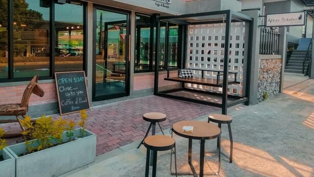 A cafe named 'After October' with outdoor seating, a sign indicating it's open from 10 AM, and a sign for coffee, food, and beer. - Pakarang Resort (La-ngu)