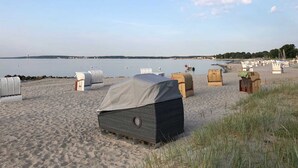 Ein Strand mit Sonnensegeln und ruhiger See.