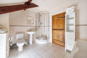 A bathroom with a toilet, sink, shower, and wooden cabinet. - Granary Barn, A Rural Retreat - Private Hot Tub, (Winkleigh)