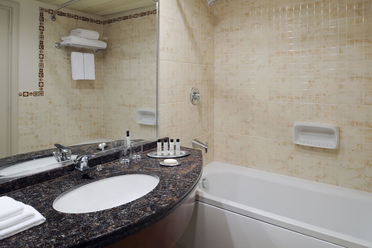 Bathtub, eco-friendly toiletries, hair dryer, bathrobes