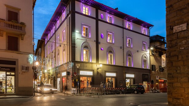 Un edificio histórico con ventanas arqueadas y un balcón, que muestra un letrero con 'BERBERESSE' y 'Caffè'.