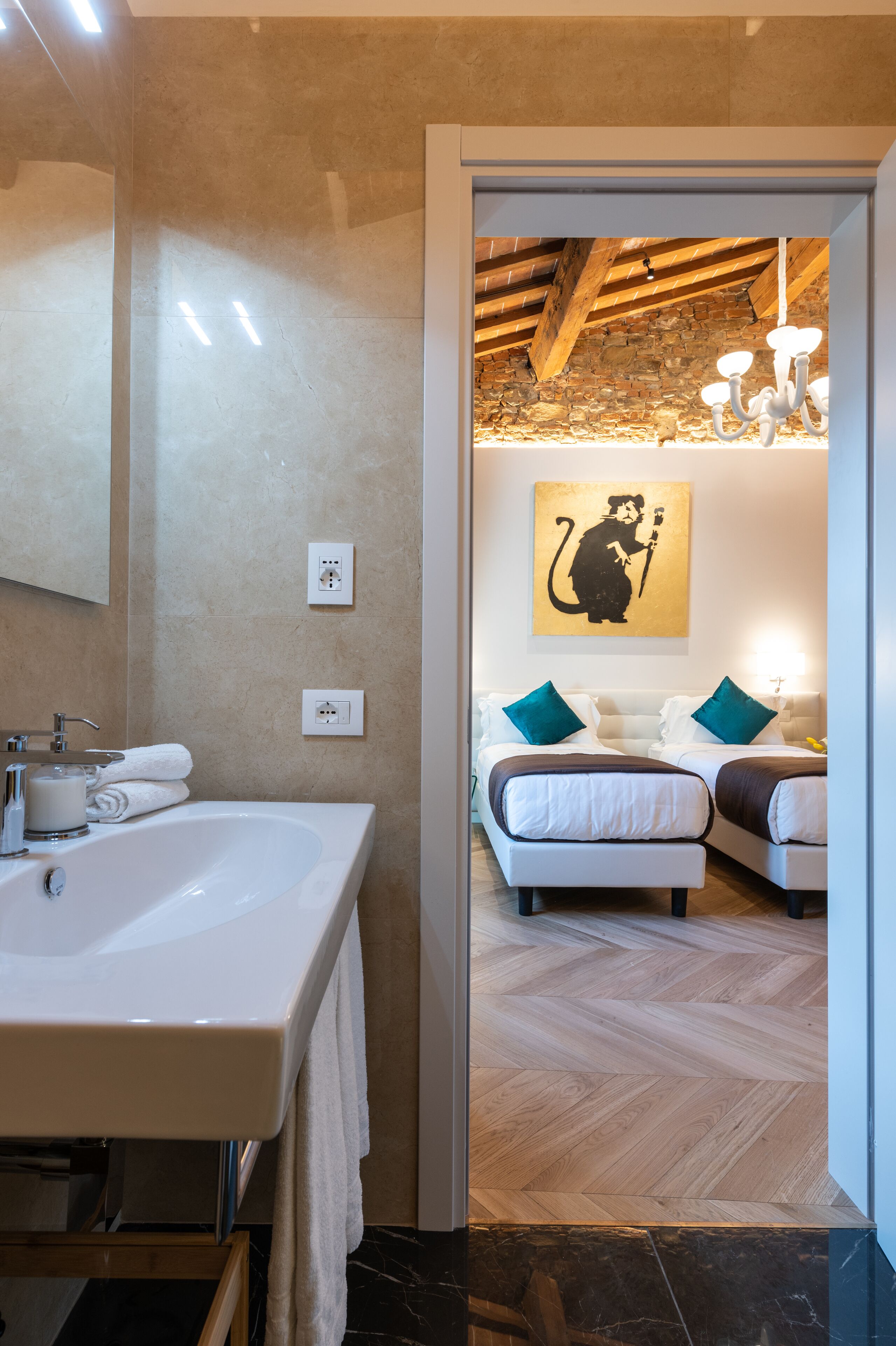 A modern bathroom with a large sink, mirror, and a wooden ceiling.