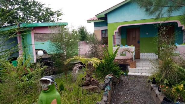 A colorful house with a paved pathway leading to the entrance. - Winner's Resort (Machakos)
