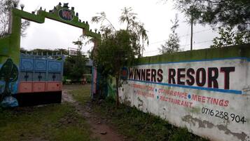 A sign for Winners Resort with amenities listed including accommodation, conference, recreation, and restaurant.