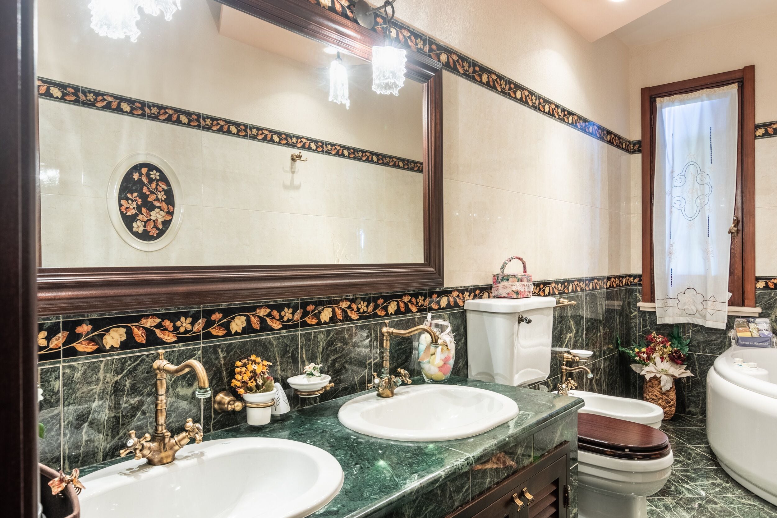 A bathroom with two sinks, a toilet, and a bathtub.
