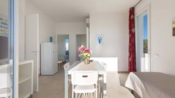 Basic Apartment, 2 Bedrooms (Trilo Primo Piano) | Living area | Flat-screen TV