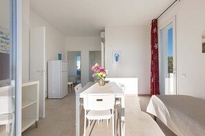 Basic Apartment, 2 Bedrooms (Trilo Primo Piano) | Living area | Flat-screen TV - Residence Mare Azzurro (Porto Cesareo)