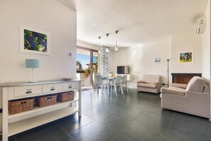 Comfort Apartment, 2 Bedrooms (Trilo con Veranda) | Living area | TV - Le Dune Villas (Porto Cesareo)