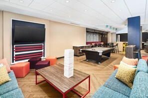 A modern lounge area with a pool table, seating, and a bar. - Tru By Hilton Ft. Lauderdale Airport (Dania Beach)