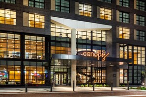 A modern building with large windows and a prominent 'canopy' sign. - Canopy by Hilton Grand Rapids Downtown (Grand Rapids)