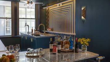 A modern kitchen with a central island, a built-in sink, and a decorative wall pattern.