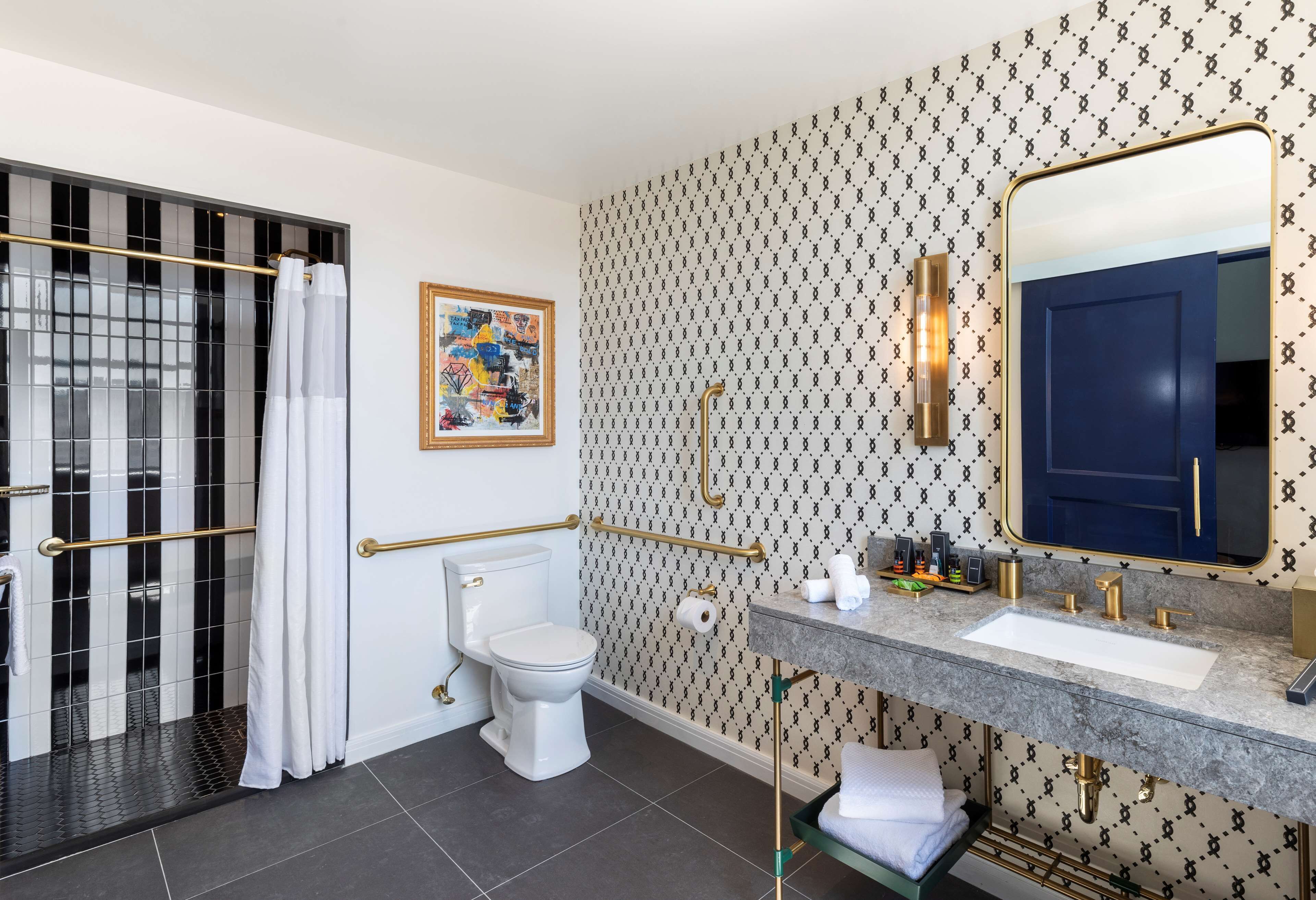 A modern bathroom with a toilet, sink, and shower area.