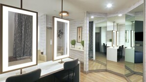 A modern interior with a reception desk, seating area, and a mirror wall. - Hilton Garden Inn Chandler Downtown (Chandler)