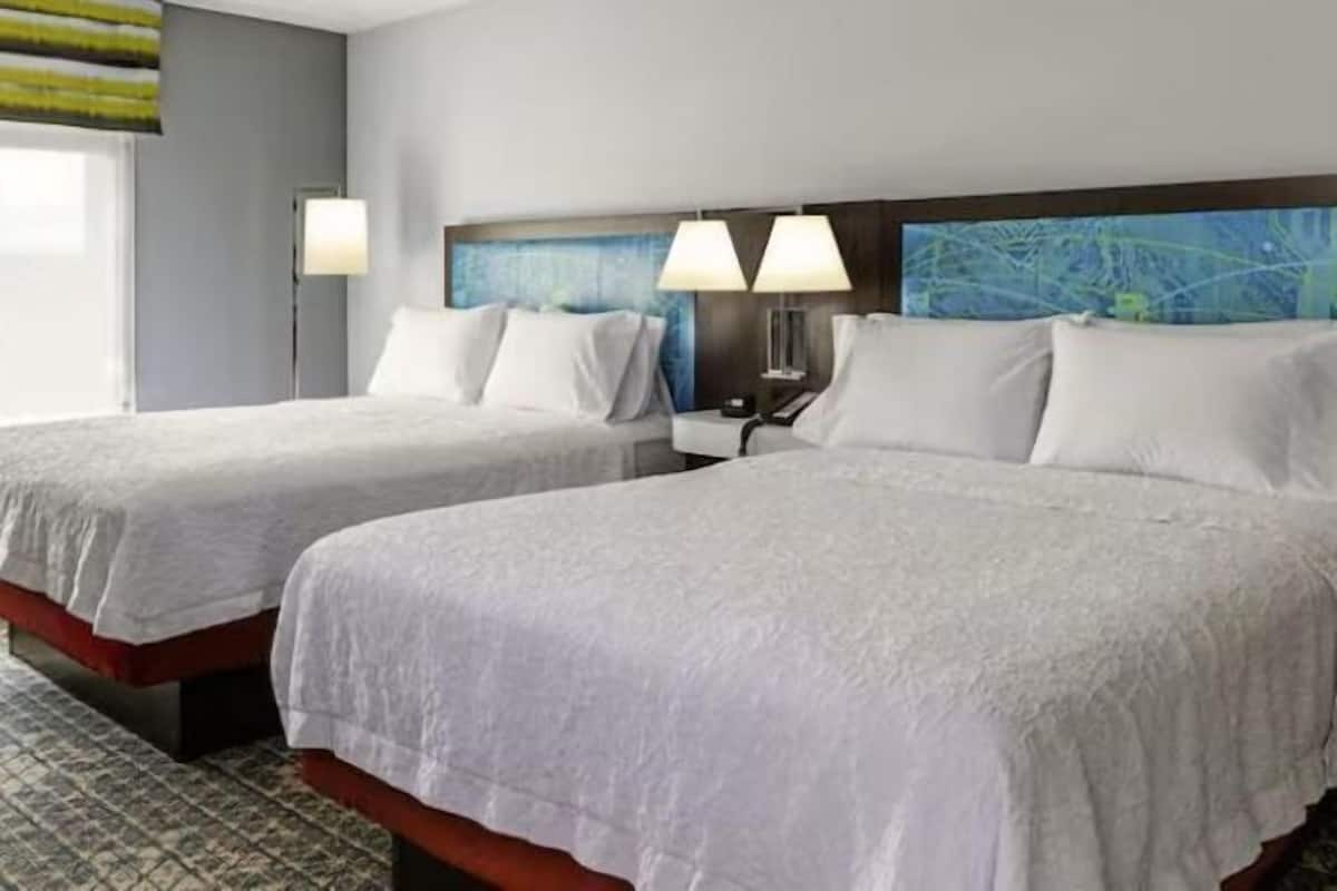 Premium bedding, desk, laptop workspace, blackout curtains