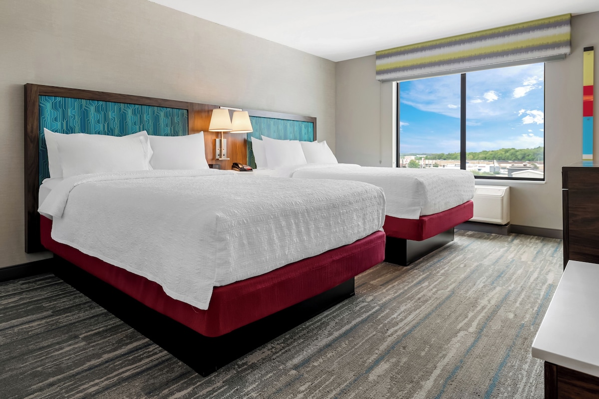 Premium bedding, desk, laptop workspace, blackout drapes